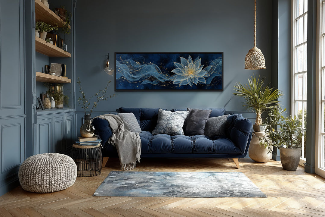 Navy blue and gold minimalist lotus flower canvas wall art hanging above a navy sofa in a room.