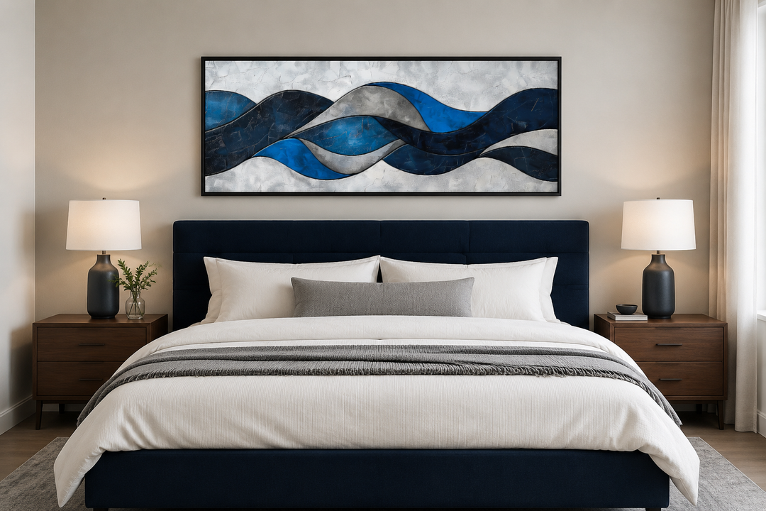 Navy blue and grey geometric abstract canvas wall art in a black frame hanging above a bed.