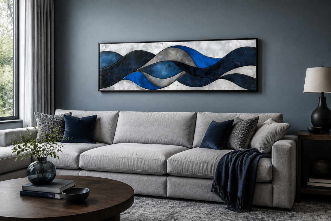Navy blue and grey geometric abstract canvas wall art in a panoramic frame above a grey sofa.