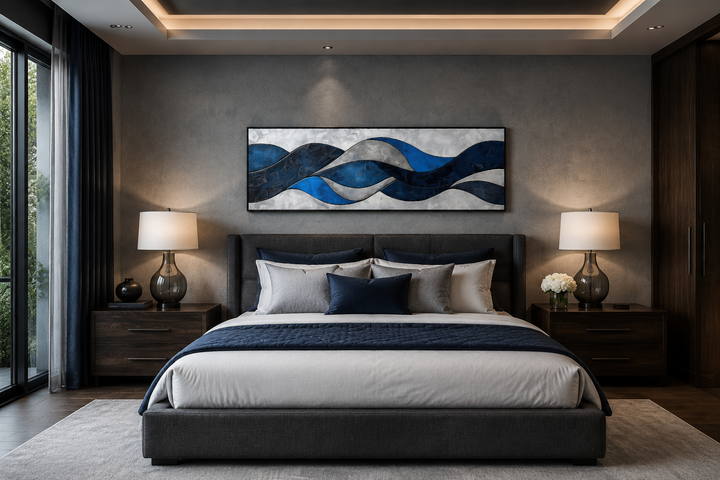 Navy blue and grey geometric abstract canvas wall art hanging above a bed in a modern bedroom.