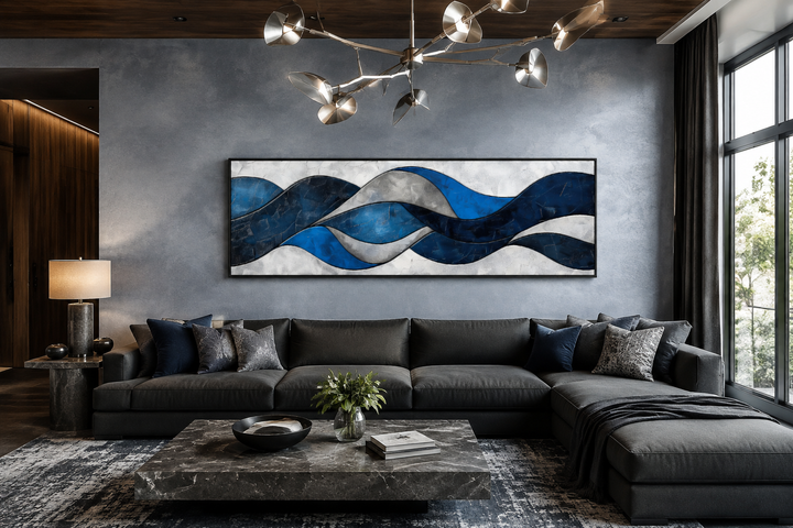 Navy blue and grey geometric abstract canvas wall art displayed above a modern dark grey sofa.