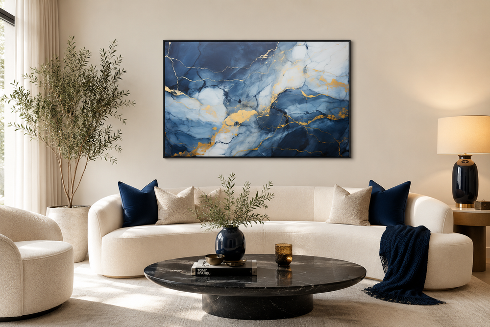 Navy blue, grey, and gold abstract marble canvas wall art framed above a white sofa.