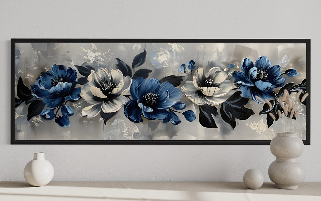 Horizontal framed canvas art with navy blue, grey, and white floral designs.