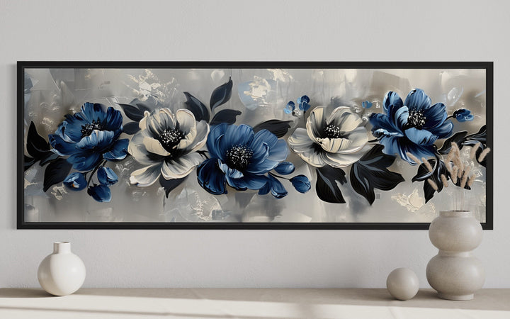 Horizontal framed canvas art with navy blue, grey, and white floral designs.