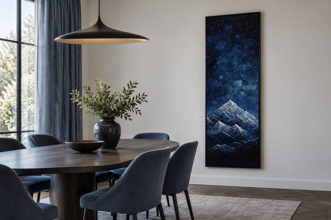 Tall narrow vertical framed canvas wall art of a navy blue starry night over majestic mountains.