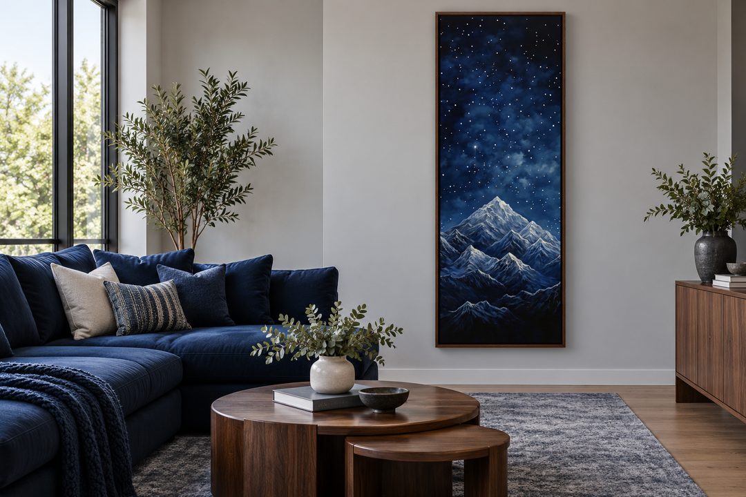 Tall narrow vertical framed canvas art of a navy blue starry night sky over majestic mountains.
