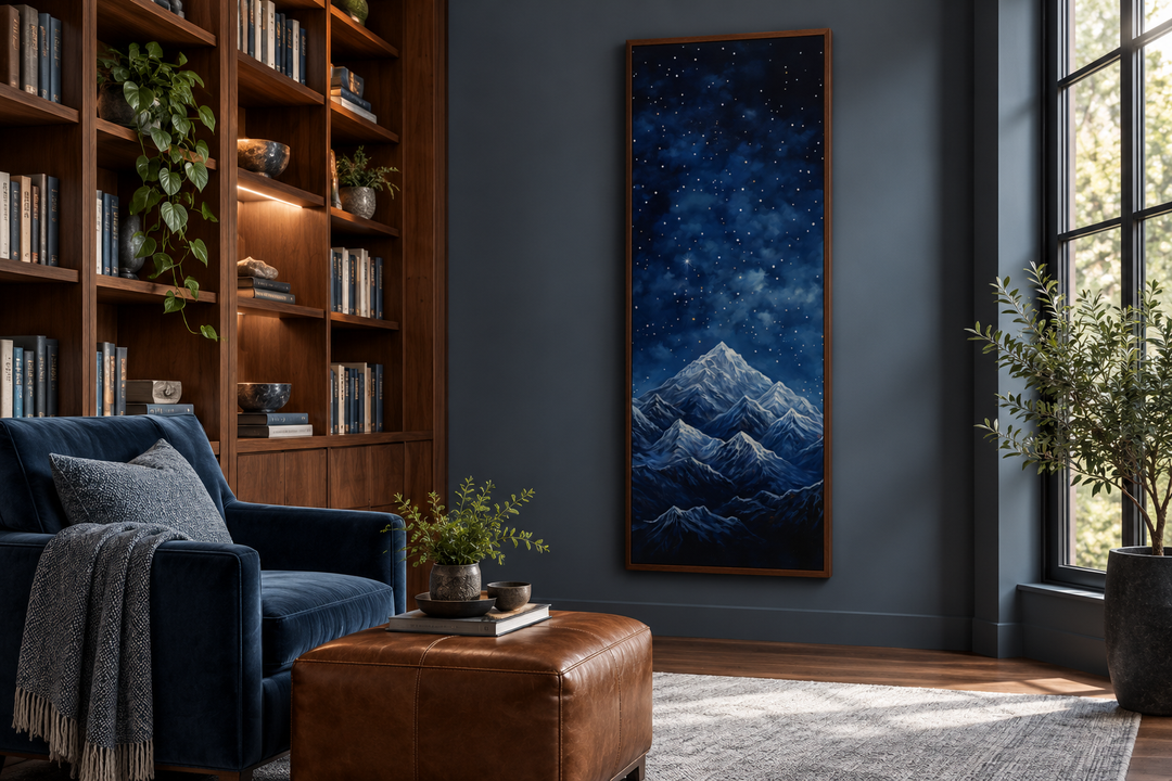 Tall narrow vertical framed canvas art of a navy blue starry night sky over snowy mountains.