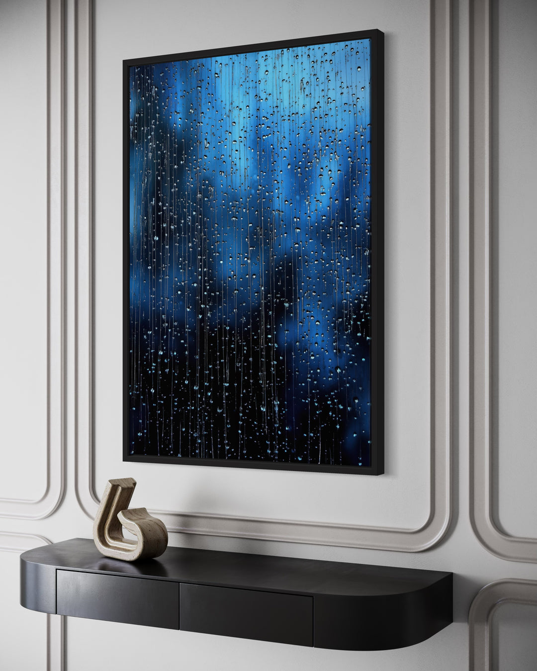 Navy blue rain drops framed canvas wall art hanging above a black console table in a modern room.