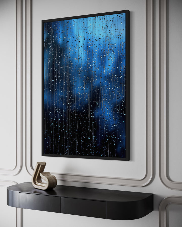 Navy blue rain drops framed canvas wall art hanging above a black console table in a modern room.