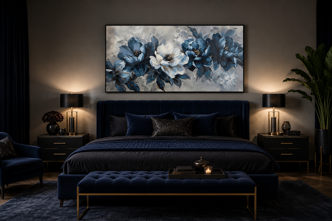 Navy blue and white abstract floral canvas wall art in a black frame above a dark blue velvet bed.