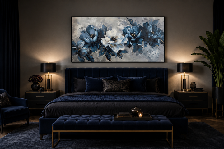 Navy blue and white abstract floral canvas wall art in a black frame above a dark blue velvet bed.