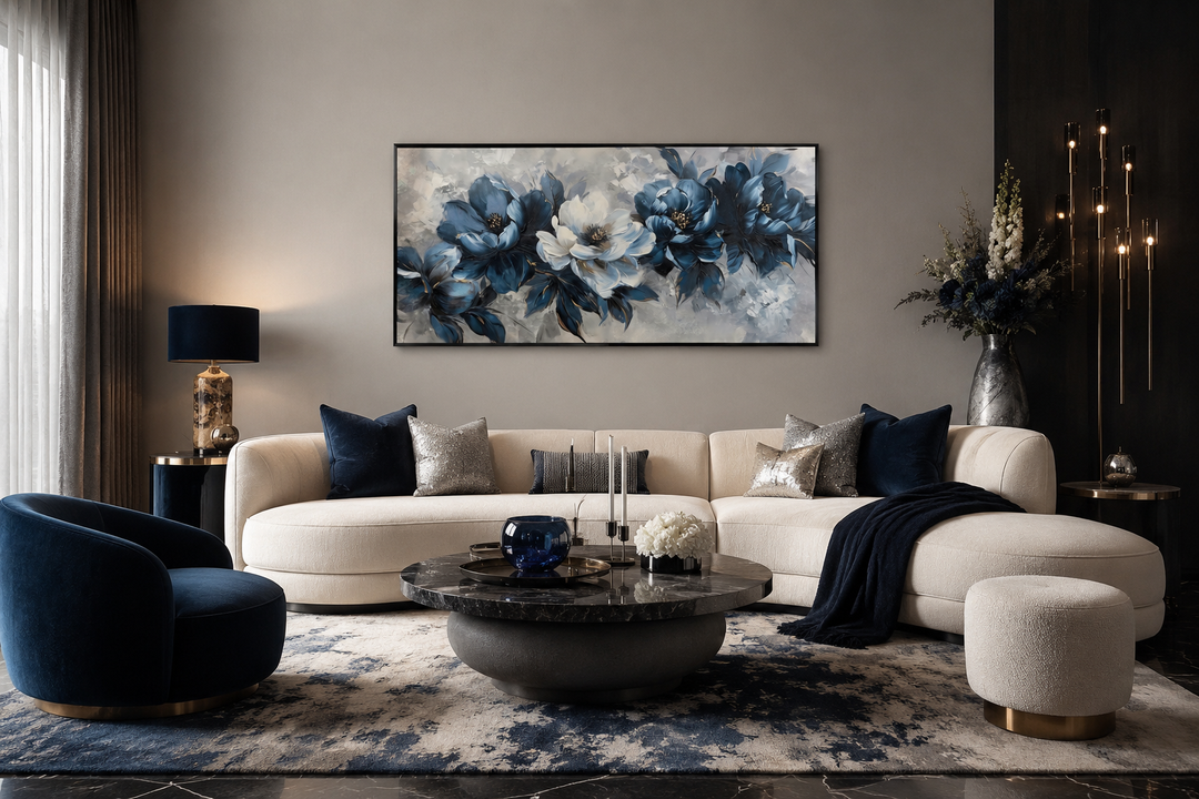 Framed navy blue and white abstract floral canvas art hanging above a modern cream sofa.
