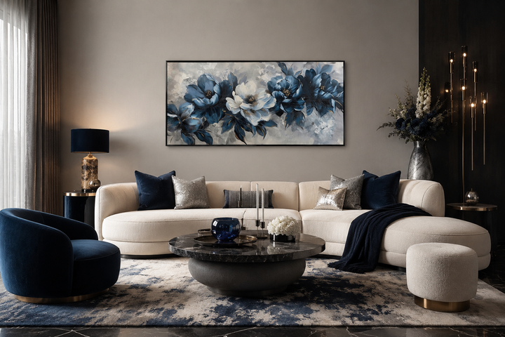 Framed navy blue and white abstract floral canvas art hanging above a modern cream sofa.