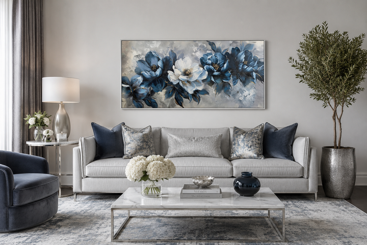 Large framed navy blue and white abstract floral canvas art hanging above a light gray sofa.