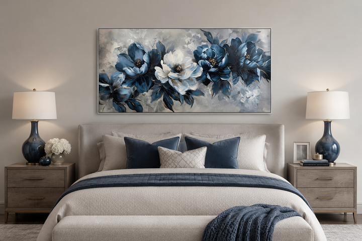Large framed navy blue and white abstract floral canvas art hanging above a bed in a modern room.