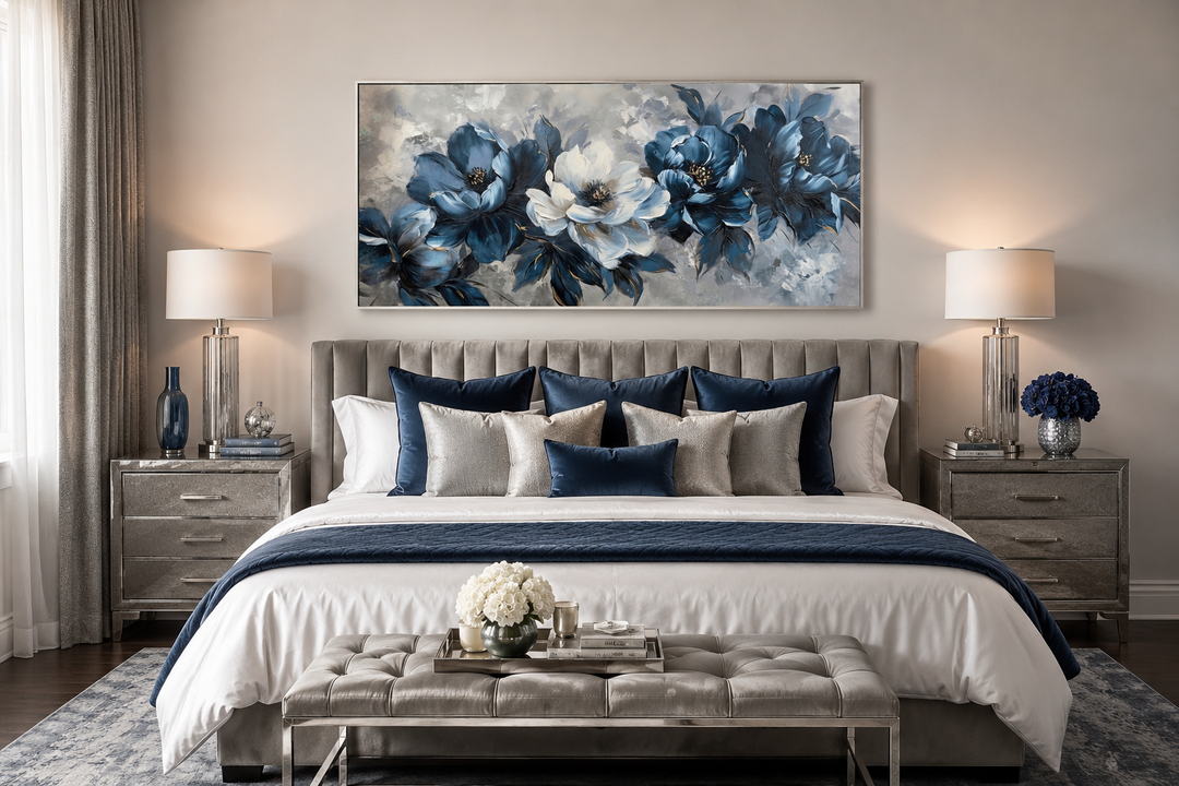 Large framed horizontal canvas featuring abstract navy blue and white flowers above a bed.