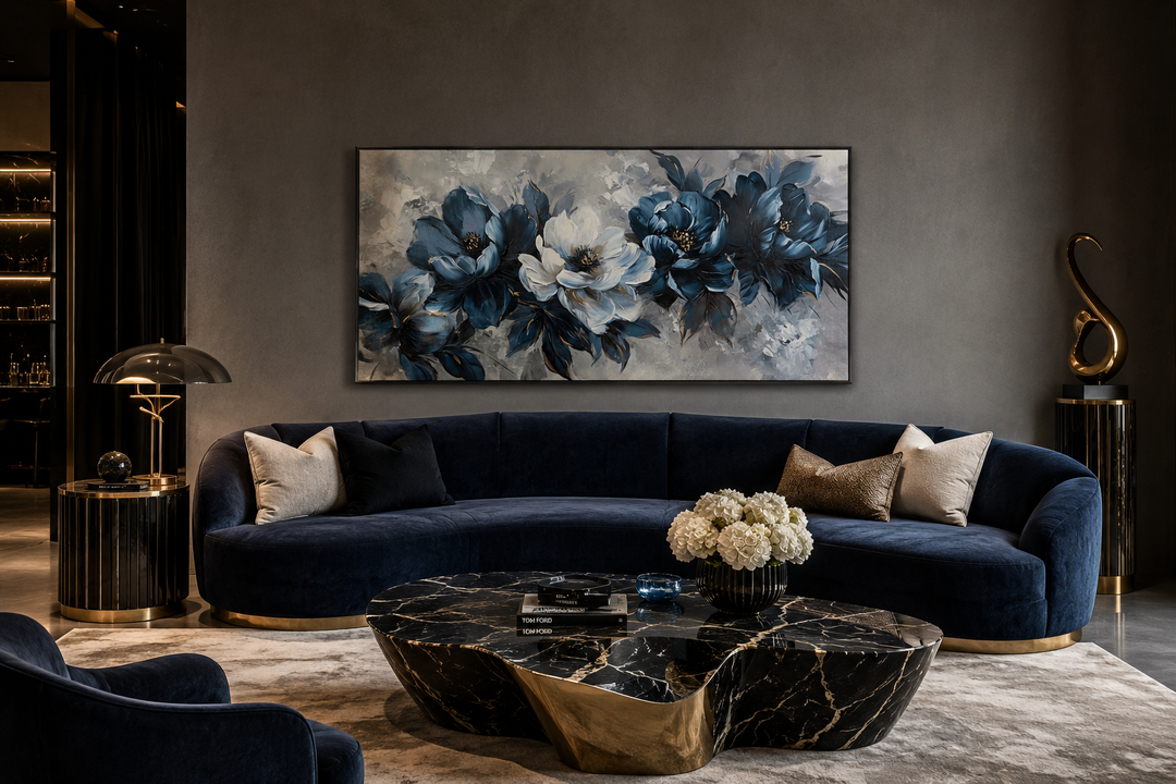 Large framed horizontal canvas featuring abstract navy blue and white flowers over a curved sofa.