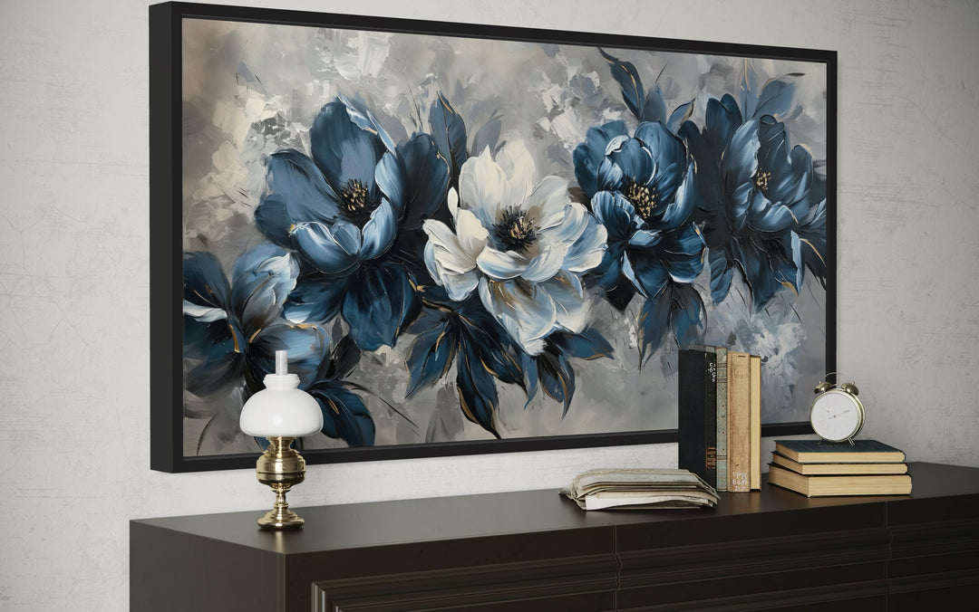 Framed navy blue and white abstract floral canvas wall art above a dark wood console table.