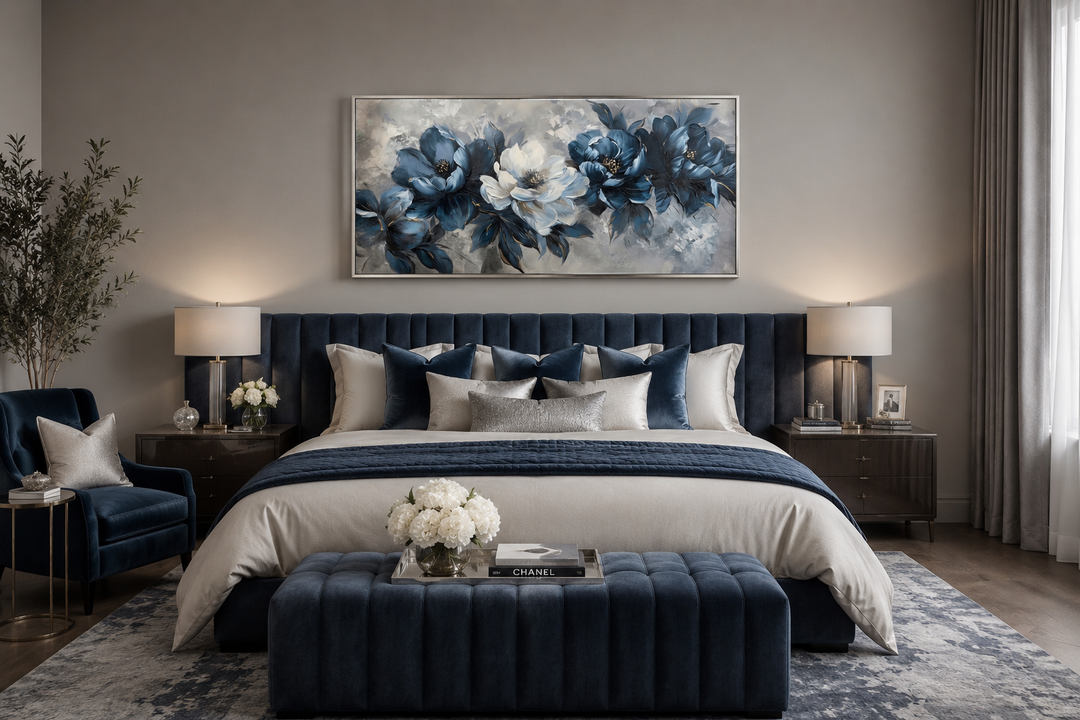 Navy blue abstract floral canvas wall art in a silver frame above a navy velvet upholstered bed.