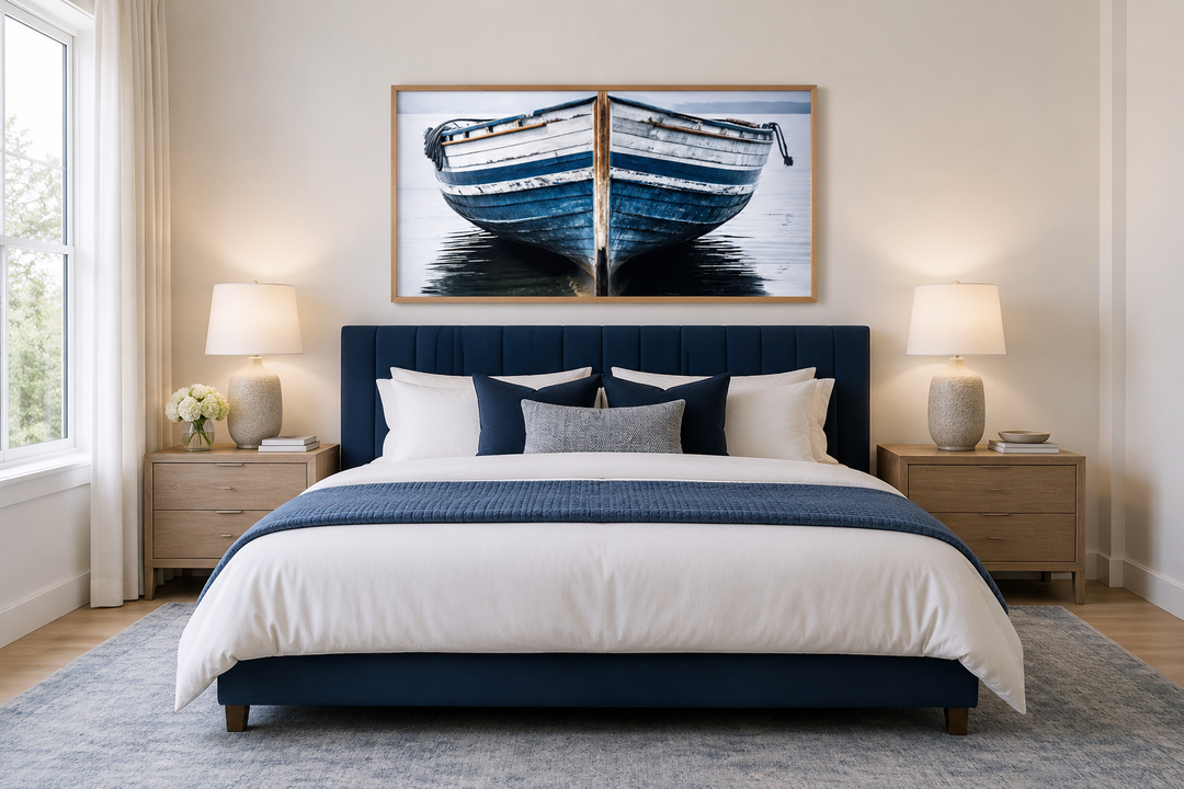 Navy blue and white old boat painting framed canvas wall art hanging above a bed in a bedroom.