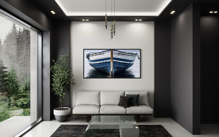Navy blue and white old boat painting framed canvas wall art hanging above a sofa in a modern room.