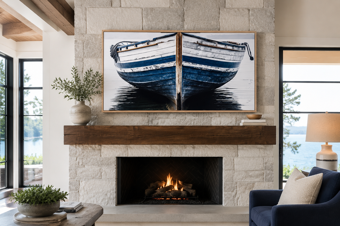 Navy blue and white old boat painting on framed canvas wall art above a stone fireplace.