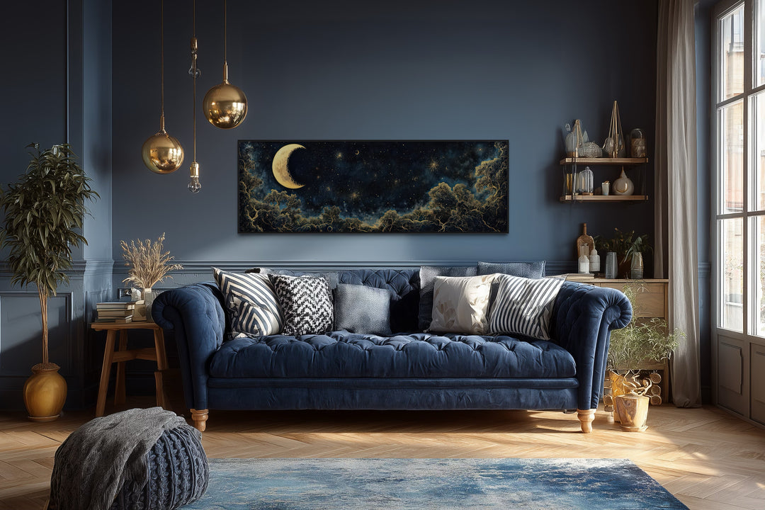 Navy blue and gold moon crescent long horizontal wall art above a blue sofa in a living room.