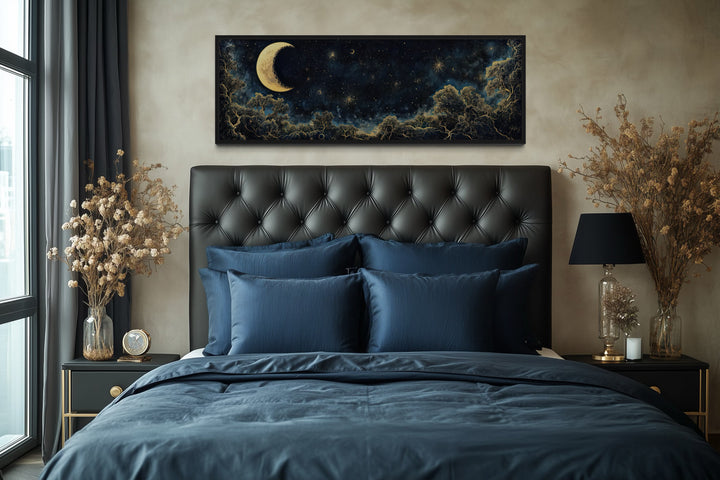 Navy blue and gold moon crescent long horizontal wall art hanging above a bed with blue bedding.