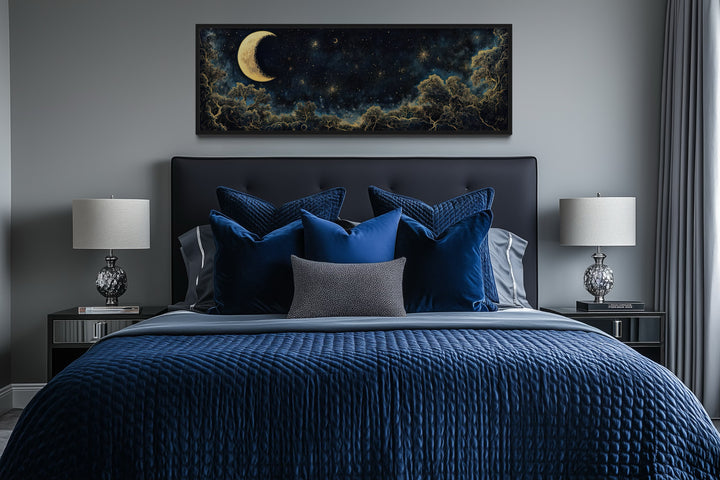 Navy blue and gold moon crescent long horizontal wall art hanging above a bed in a modern bedroom.