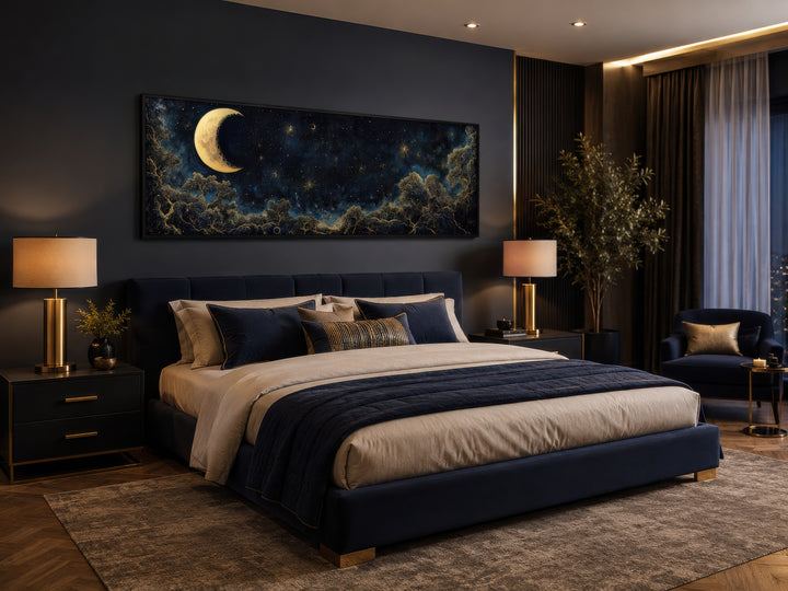 Navy blue and gold moon crescent long horizontal wall art above a bed in a dark bedroom.
