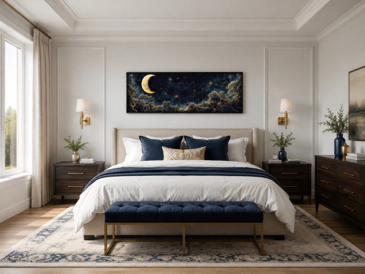 Long horizontal wall art of a gold crescent moon and starry night sky above a bed.