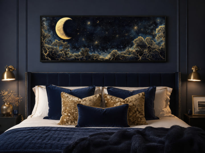 Navy blue and gold moon crescent long horizontal wall art hanging above a bed in a bedroom.