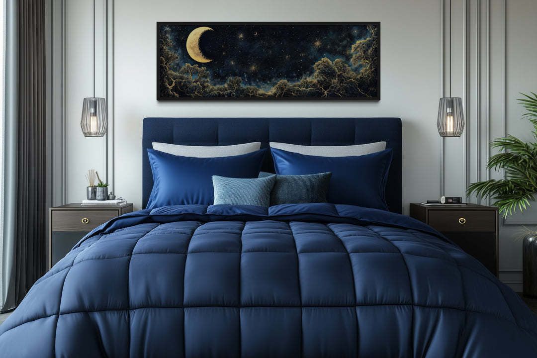 Navy blue and gold moon crescent long horizontal wall art hanging above a bed in a bedroom.