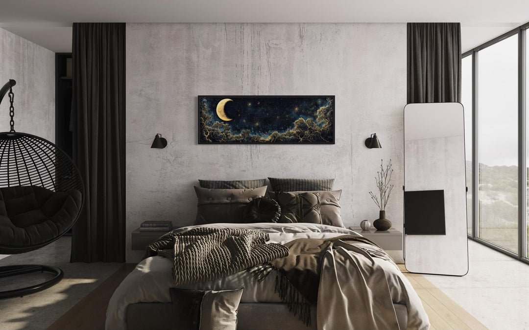 Navy blue and gold moon crescent long horizontal wall art hanging above a bed in a modern bedroom.