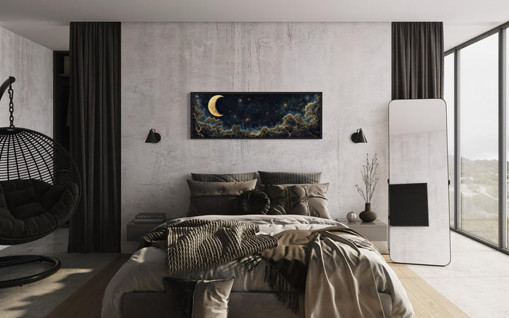 Navy blue and gold moon crescent long horizontal wall art hanging above a bed in a modern bedroom.