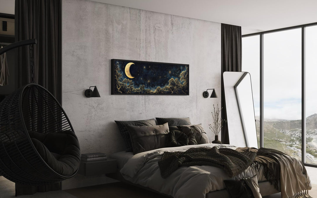Navy blue and gold moon crescent long horizontal wall art hanging above a bed in a modern bedroom.