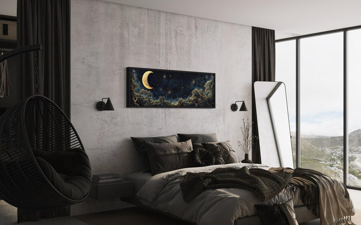 Navy blue and gold moon crescent long horizontal wall art hanging above a bed in a modern bedroom.