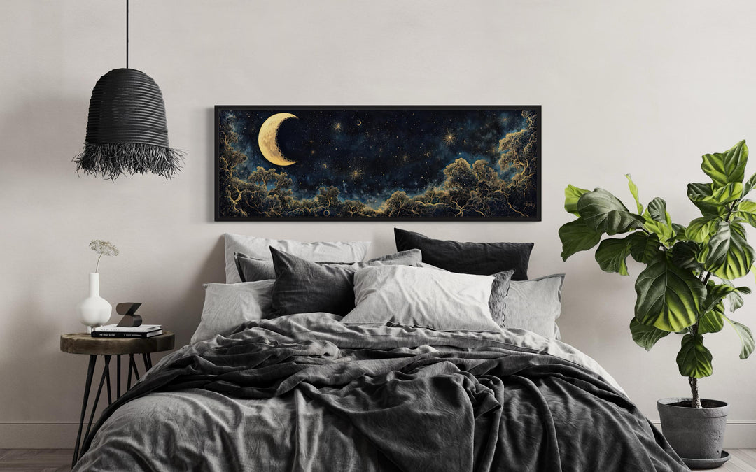 Navy blue and gold crescent moon and starry night sky horizontal wall art above a bed.