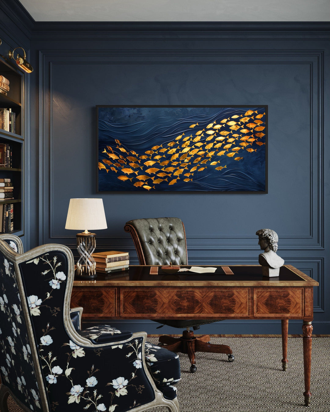 Framed navy blue canvas wall art featuring a school of shimmering gold fish in a home office.