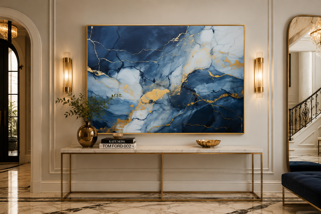 Navy blue, grey, and gold abstract marble canvas wall art above a console table in a modern hallway.