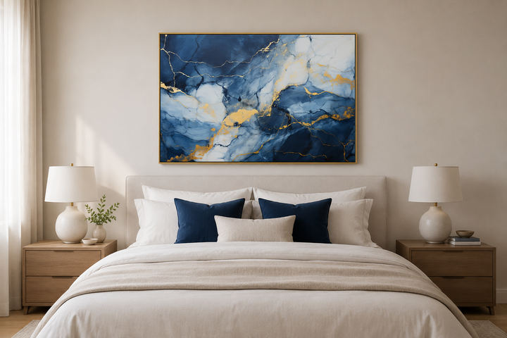 Navy blue, grey, and gold abstract marble canvas wall art framed above a bed in a modern bedroom.