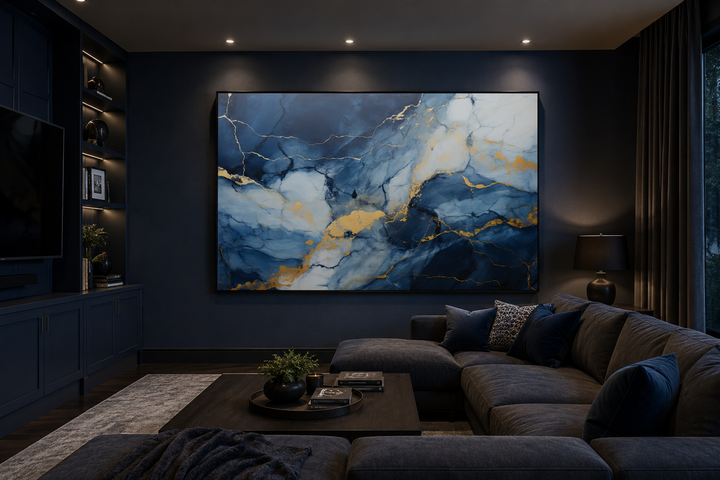 Large abstract marble canvas wall art in navy blue, grey, and gold above a dark sectional sofa.