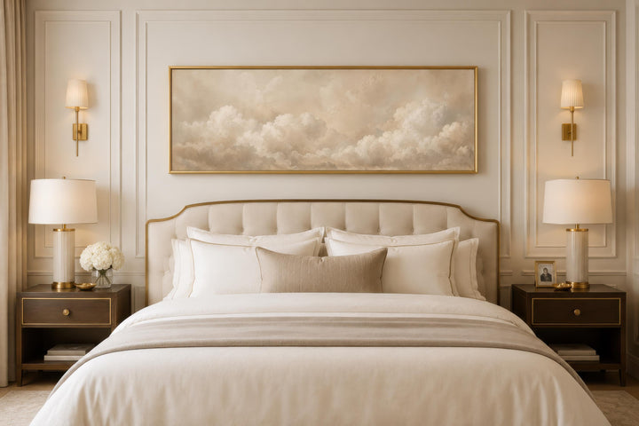Long horizontal canvas art of beige and white clouds above a bed in a neutral-toned bedroom.