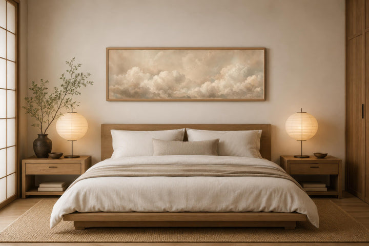 Long narrow horizontal wall art of white clouds on a beige background above a wooden bed frame.