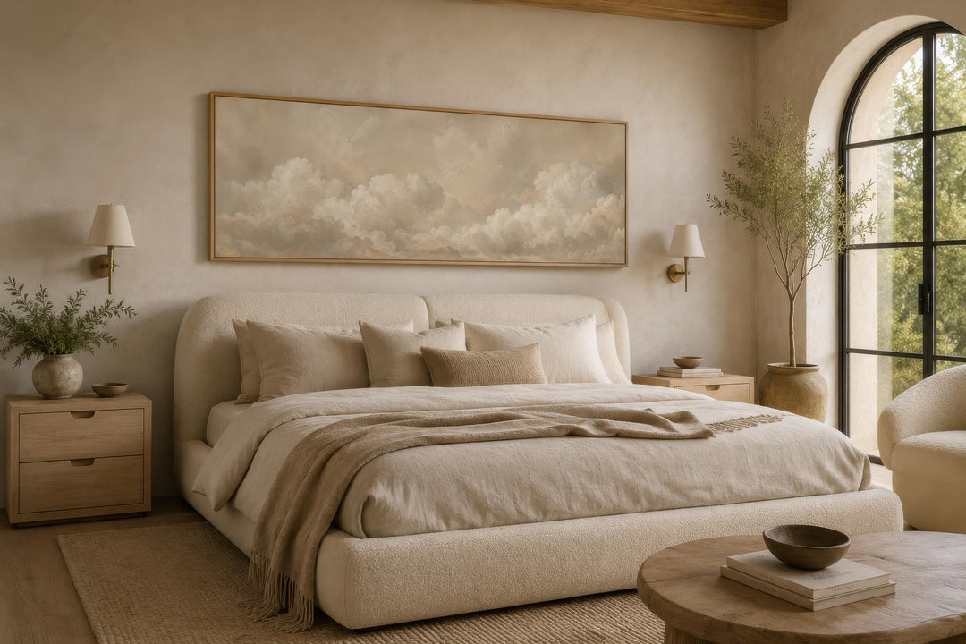 Long narrow horizontal wall art featuring soft beige and white clouds above a neutral bed.