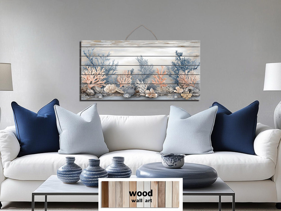 Horizontal wood wall art featuring coral in beige, blue, and peach tones above a white sofa.