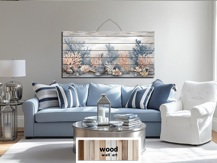 Neutral coral and blue coastal scene printed on a horizontal distressed wood plank wall art piece.