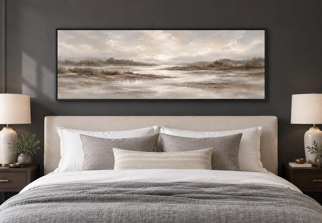 Neutral earth tones river landscape long horizontal canvas wall art hanging above a bed.