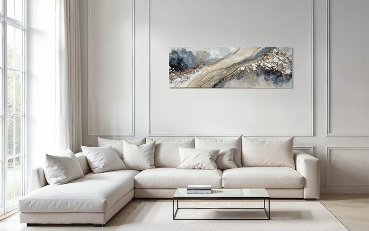 Neutral grey, beige, and gold horizontal abstract canvas art hanging above a modern white sofa.