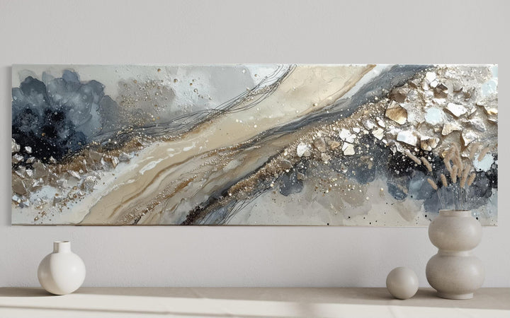 Long horizontal abstract canvas wall art featuring neutral grey, beige, and gold textured strokes.
